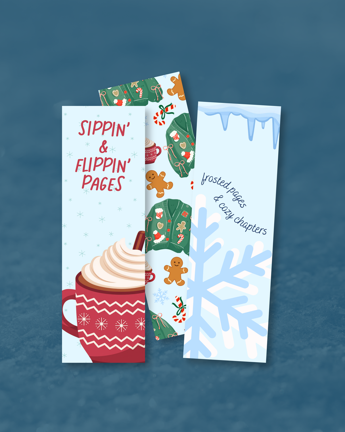 Three Christmas-themed bookmark cards fanned out on a textured blue background. The left card is light blue with red text reading 'Sippin' & Flippin' Pages' above a red mug with whipped cream and a cinnamon stick.