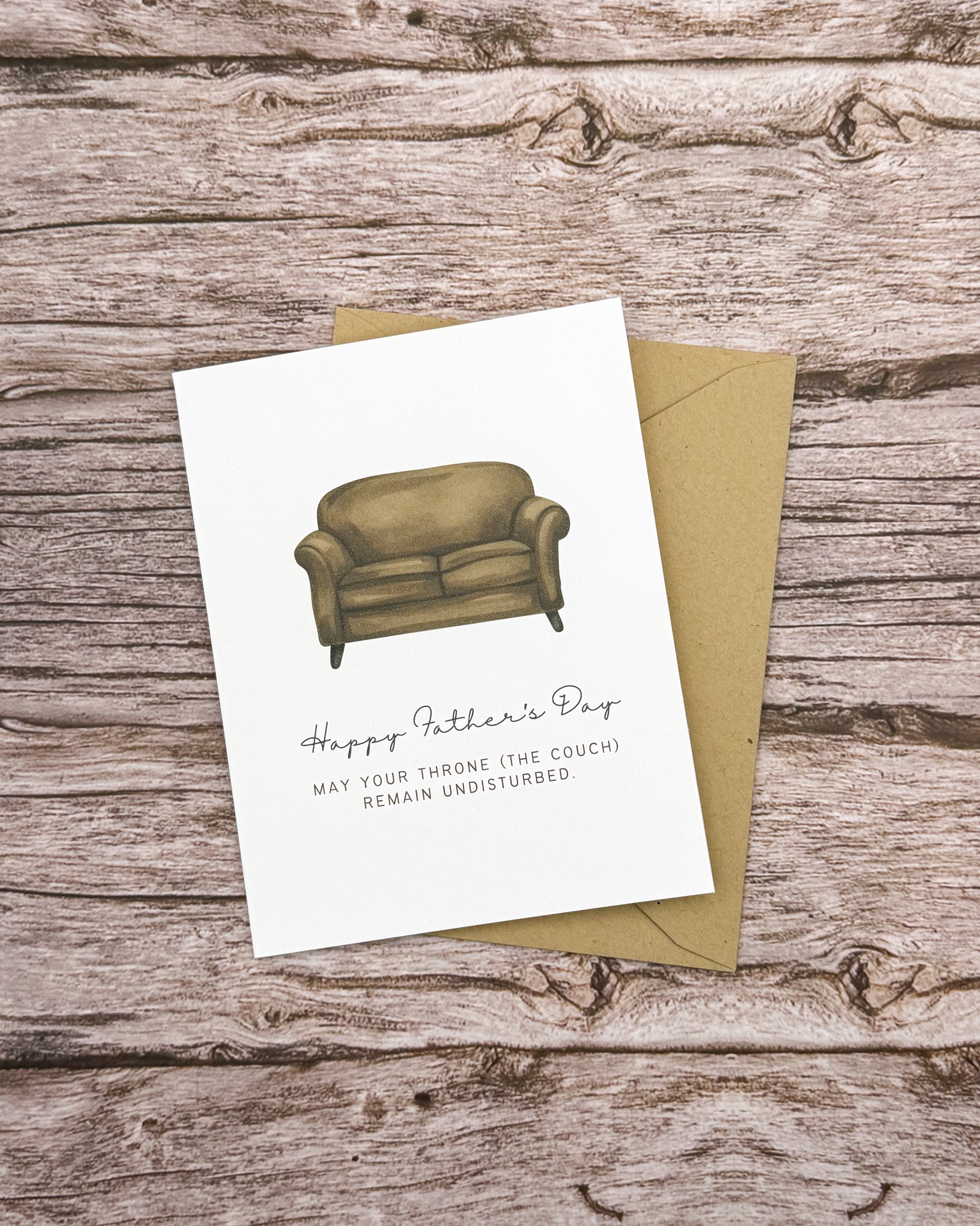 Father's Day card with a couch illustration on a wooden surface