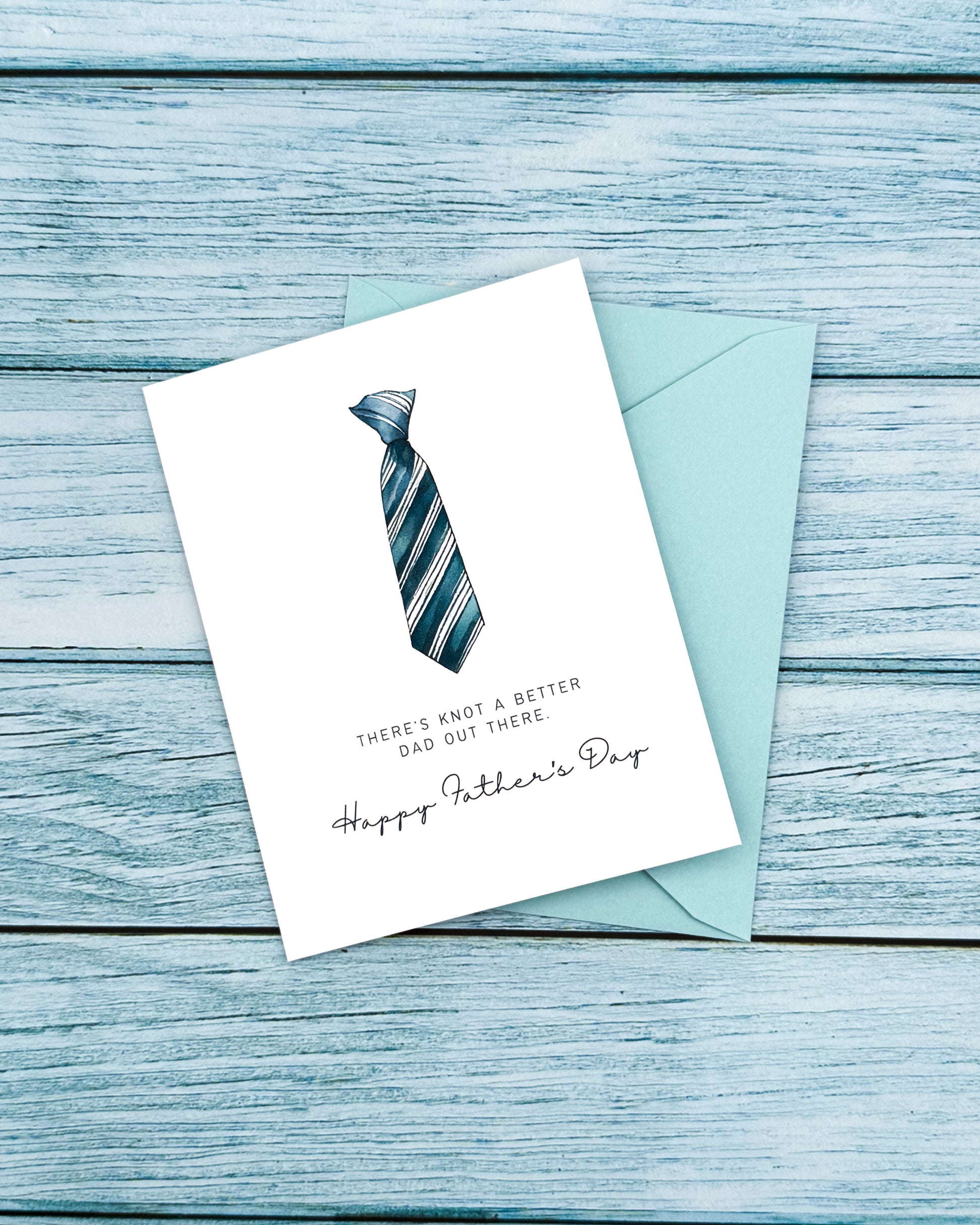 Father's Day card with a tie illustration and envelope on a wooden surface