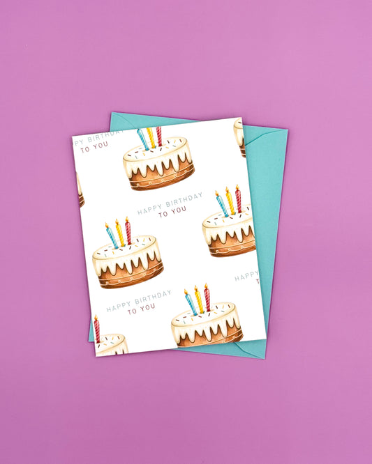 Birthday card with cake illustrations and candles on a purple background