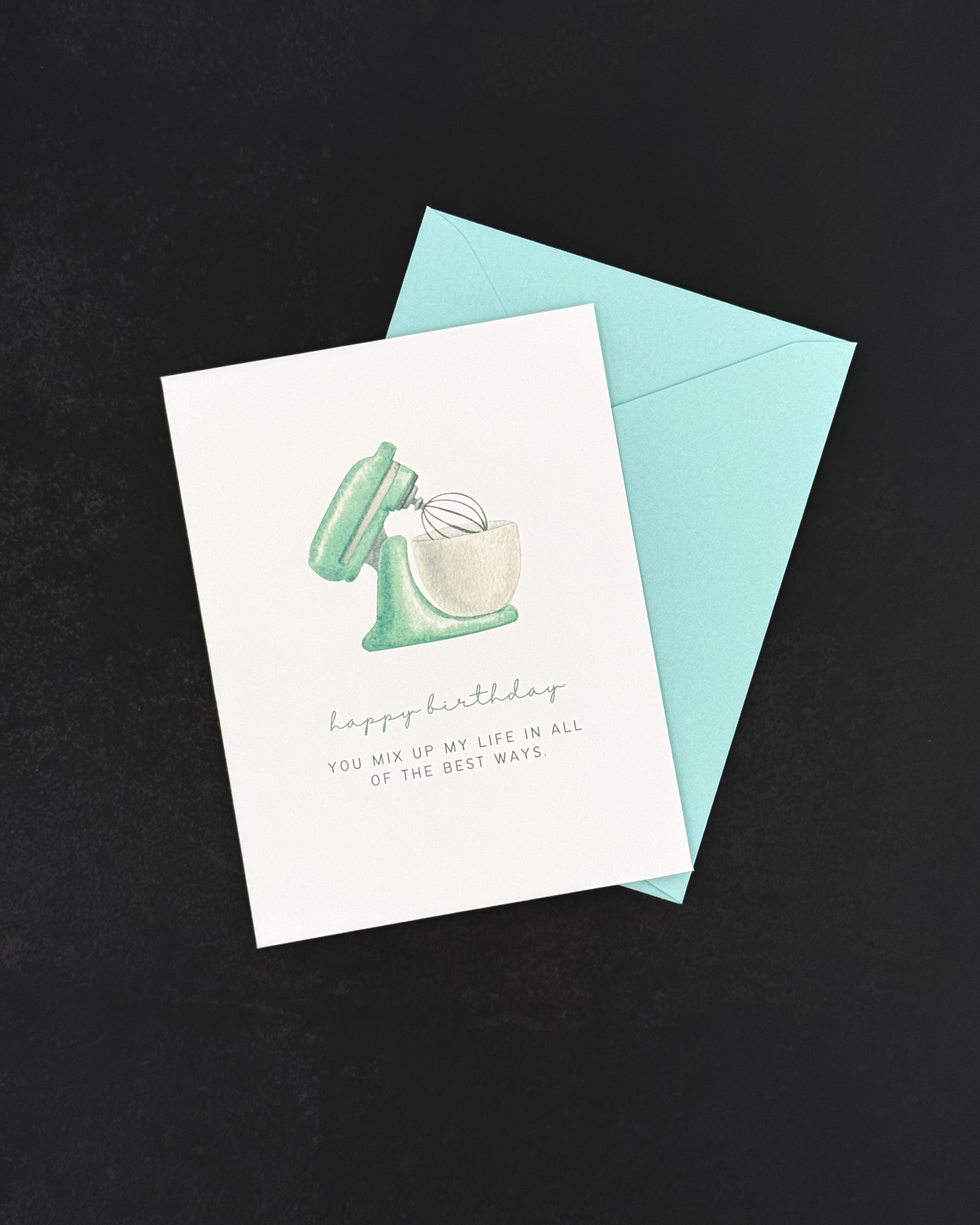 Greeting card with mixer illustration and blue envelope on black background
