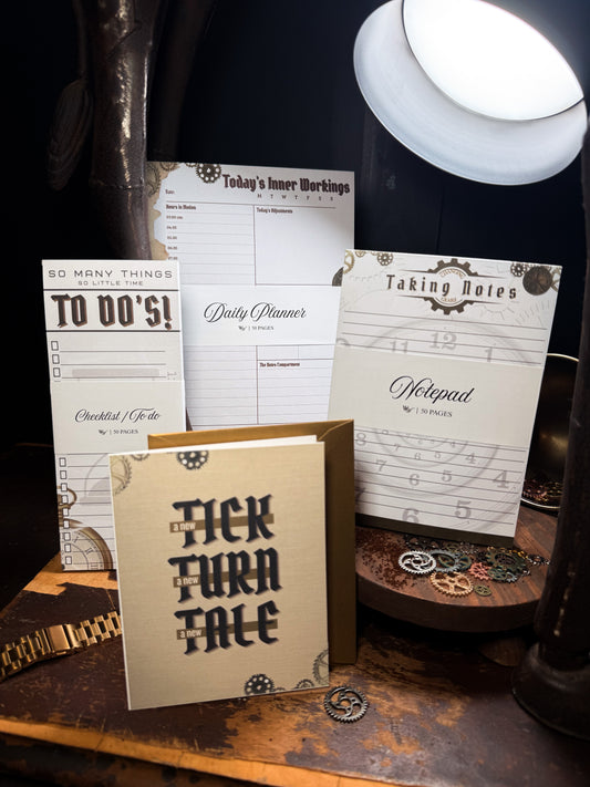 Collection of stationery items including a daily planner, to-do list, and notepad on a wooden surface with a lamp in the background.