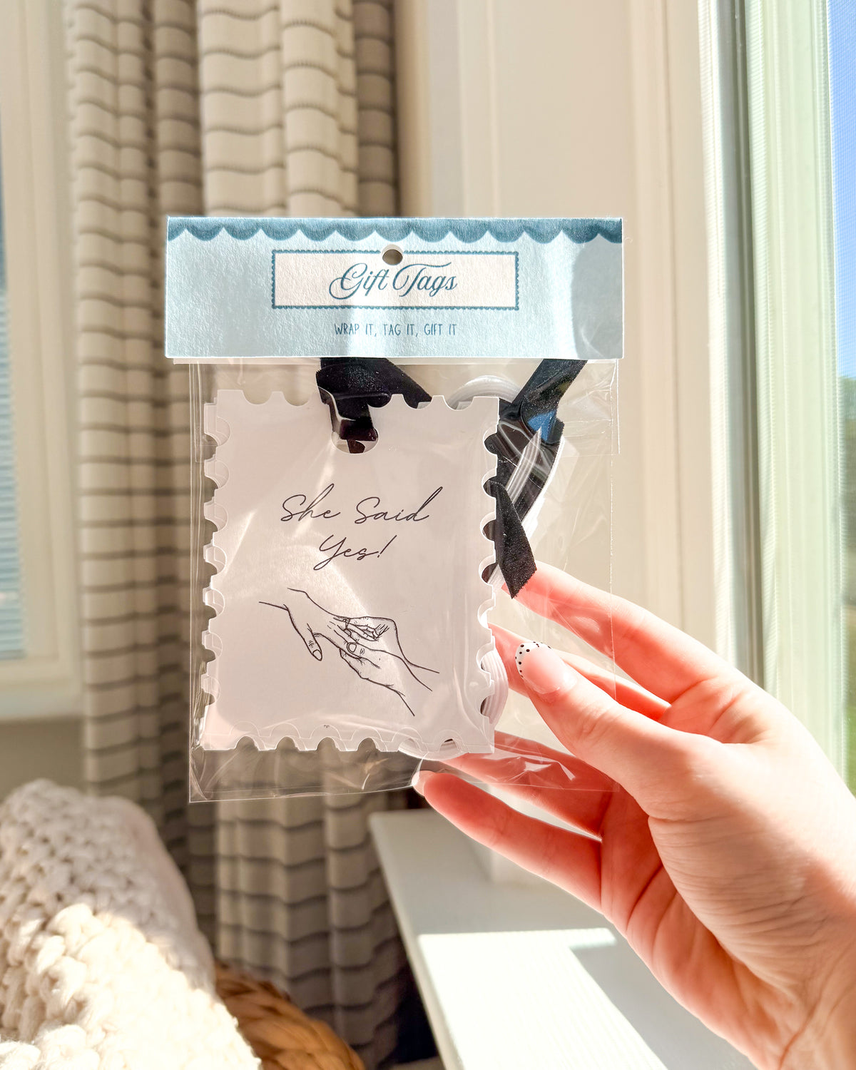 A hand holding a packaged novelty gift card set. The clear plastic bag contains two white scalloped gift cards with black printed text and illustrations, attached to a light blue header card that reads 'Gift Guys'.