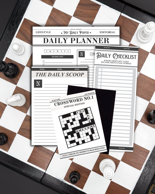 Set of daily planner sheets on a chessboard with chess pieces.