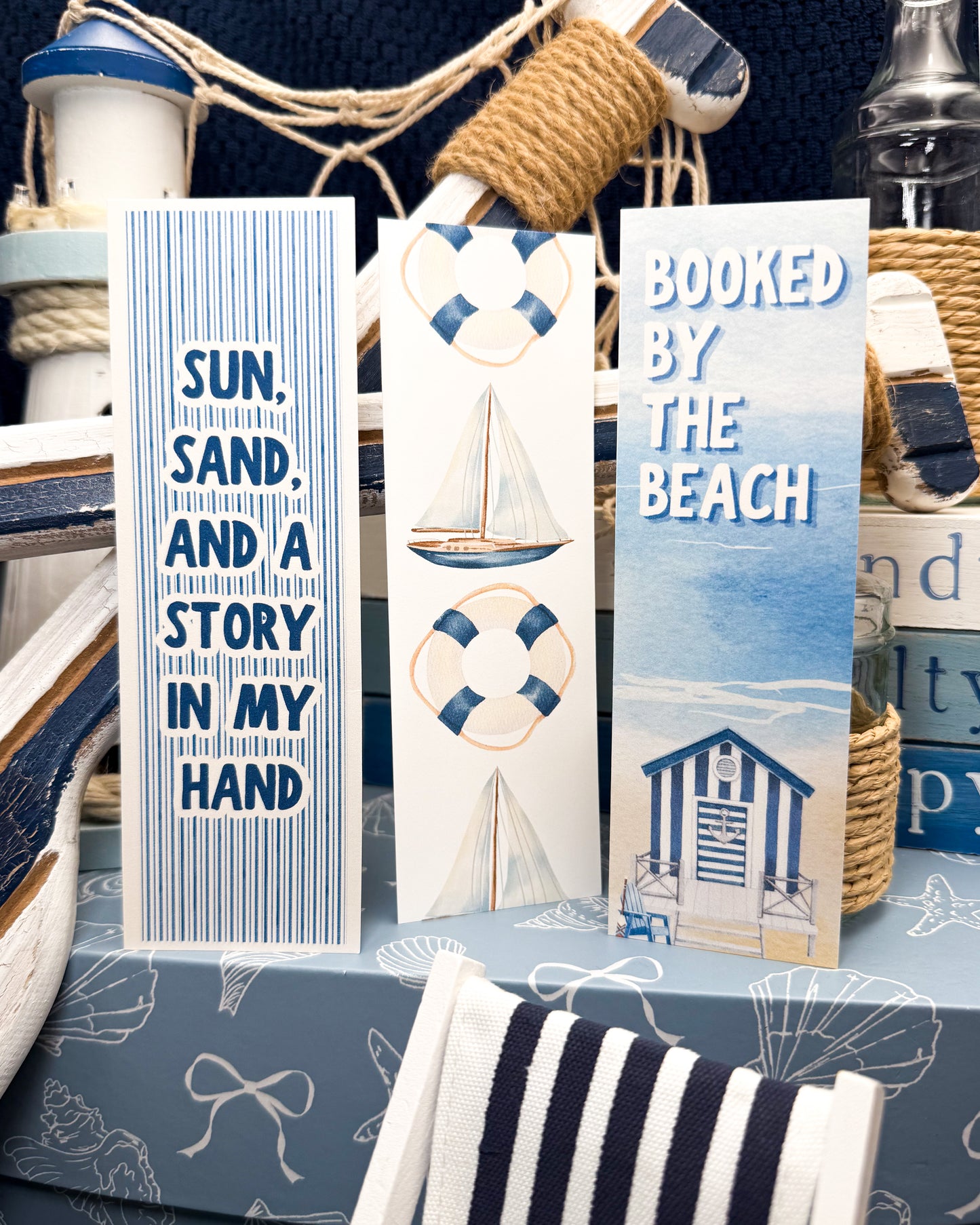 Decorative bookmarks with beach-themed designs and text on a nautical-themed background.