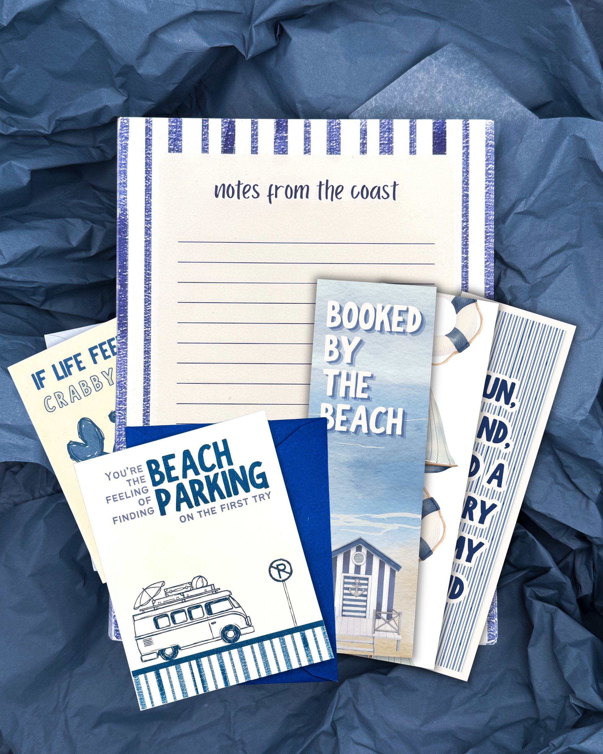 Set of beach-themed stationery items on a blue textured background