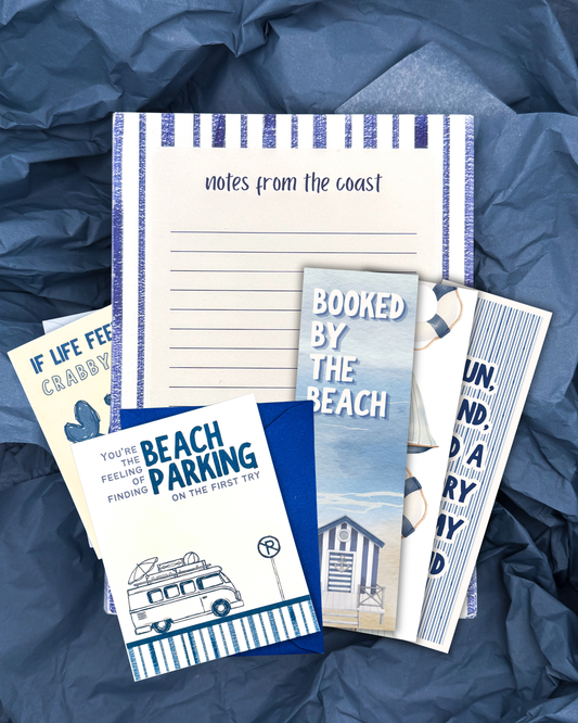 Set of beach-themed stationery items on a blue textured background