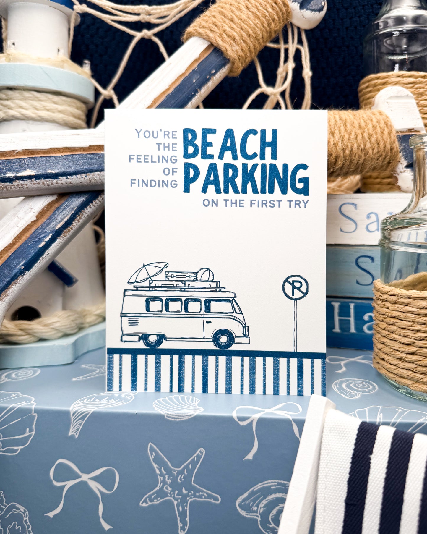 Nautical-themed decor with a greeting card about beach parking and a van illustration.