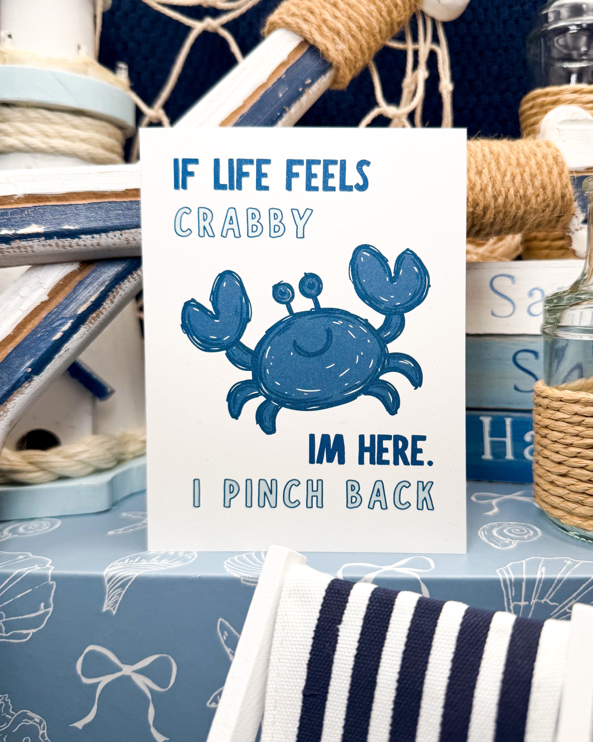 Nautical-themed decor with a greeting card featuring a blue crab and humorous text.